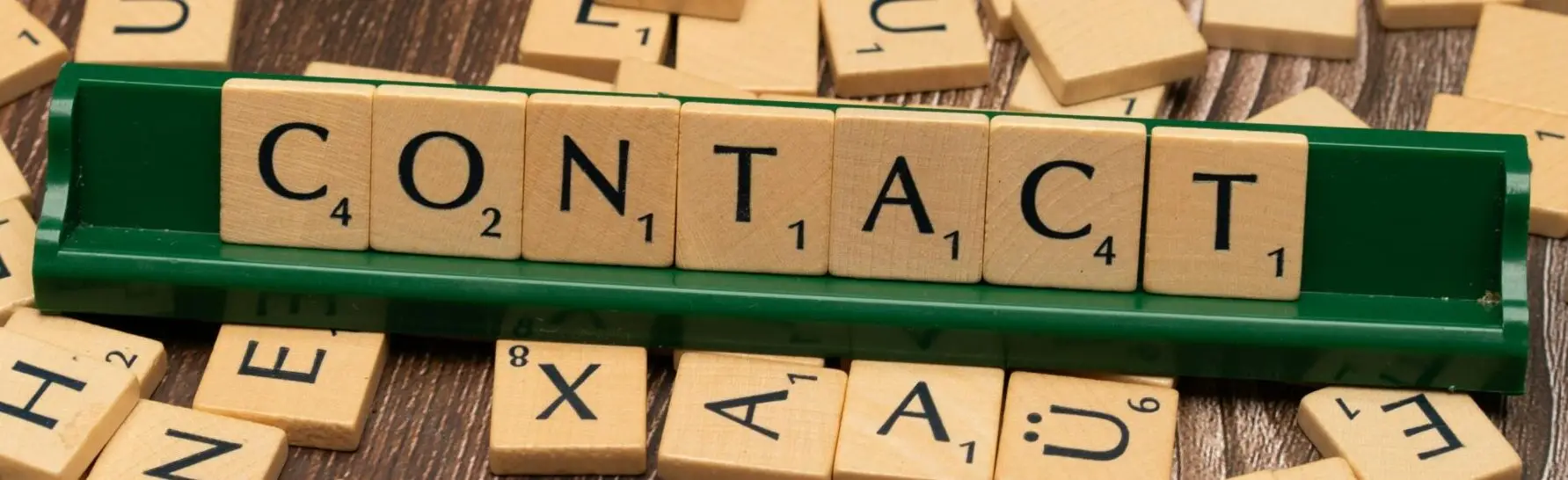 The word contact is spelled out with wooden letters