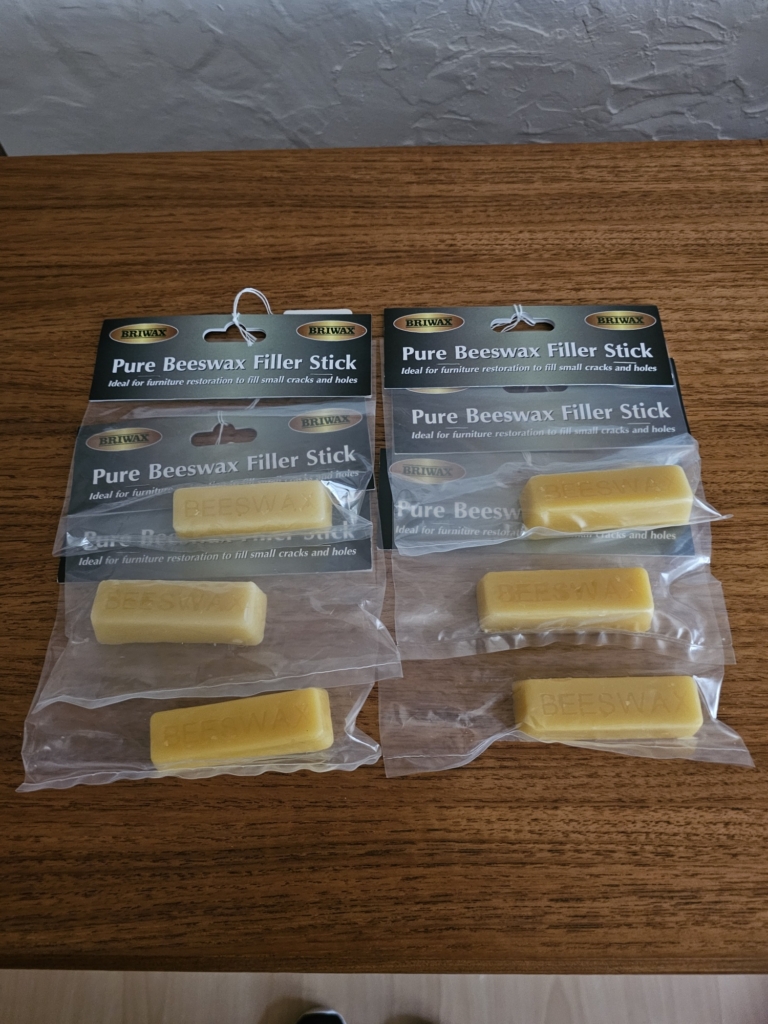 Briwax Pure Beeswax Filler Sticks in original packaging, ideal for repairing small cracks and holes in wooden furniture.